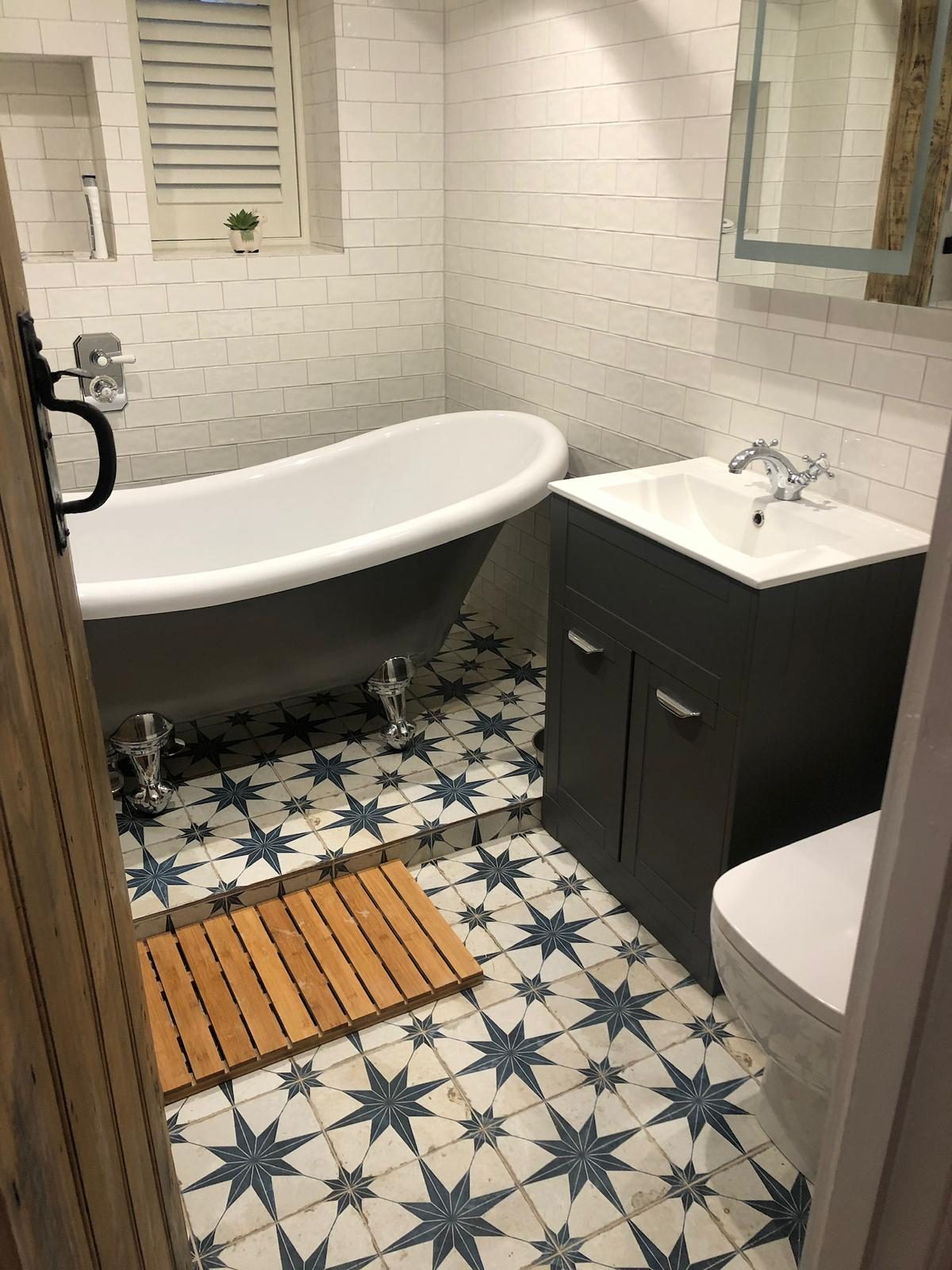Family bathroom with claw-foot bath and patterned floor tile