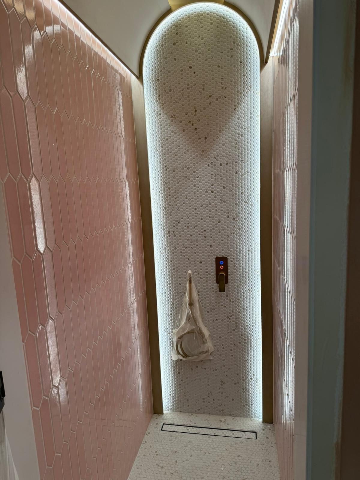 Newly fitted bathroom with hex tile arch and gold trim, by Centaurus Construction
